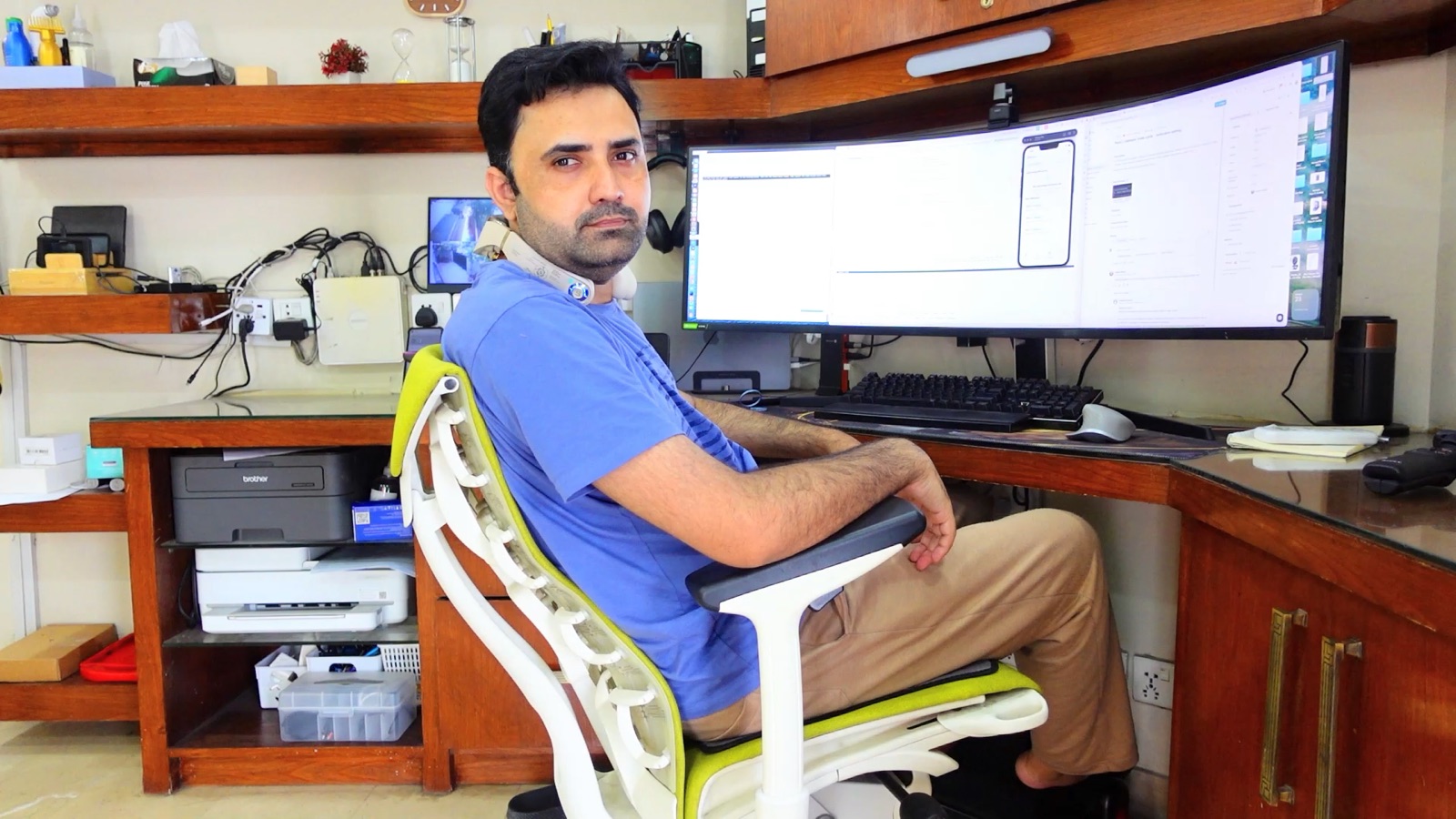 Ramiz at his remote workstation with a curved ultrawide monitor