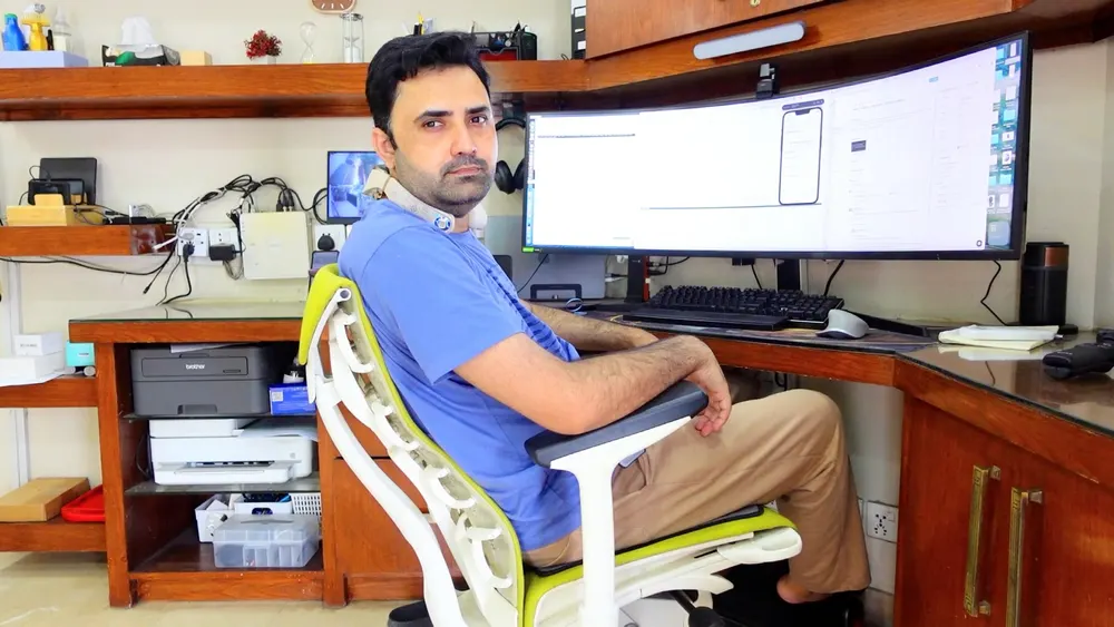 Ramiz at his remote workstation with a curved ultrawide monitor